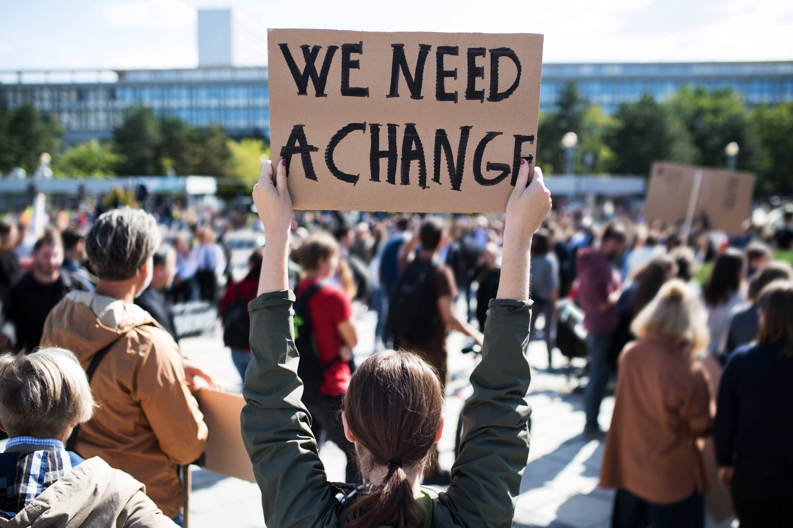 Rear,View,Of,People,With,Placards,And,Posters,On,Global We need change image