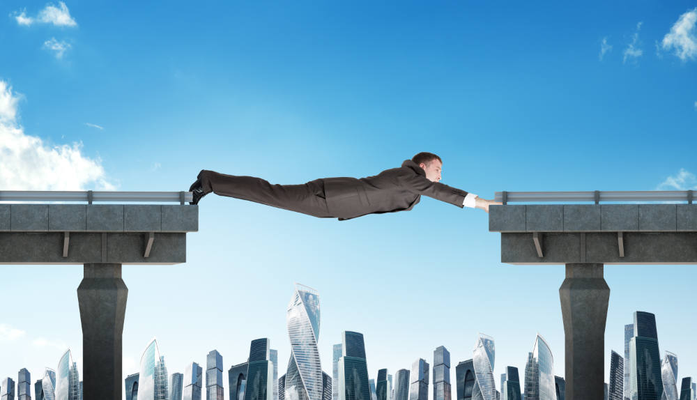 Businessman,Linking,Broken,Bridge Businessman linking broken bridge